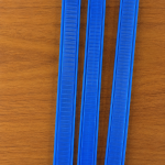 Close-up of blue aluminum and PE surgical shaping strips showing smooth surface texture