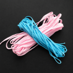 Crossed bundles of pink and blue elastic mask earloops showing high resilience and soft texture