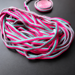 Pink and cyan seersucker elastic earloops showing soft texture and high resilience