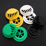 Circular welded exhalation valves with yellow and green silicone diaphragms for low breathing resistance